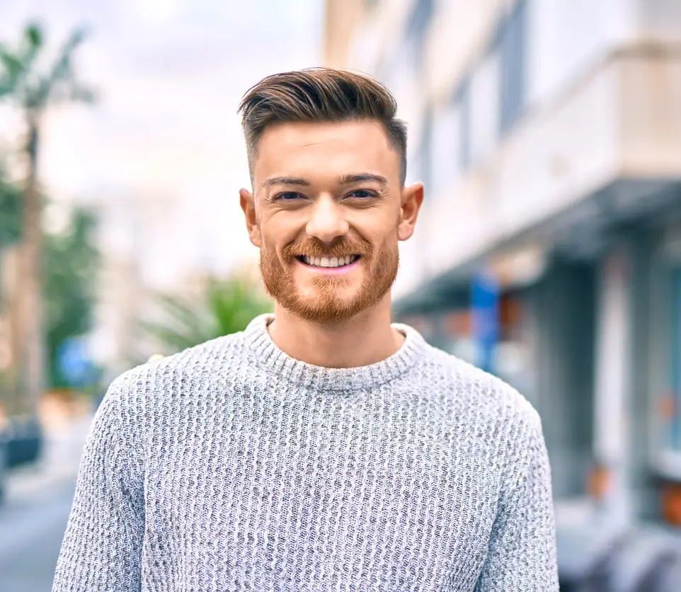 Young caucasian man smiling happy standing at the city.