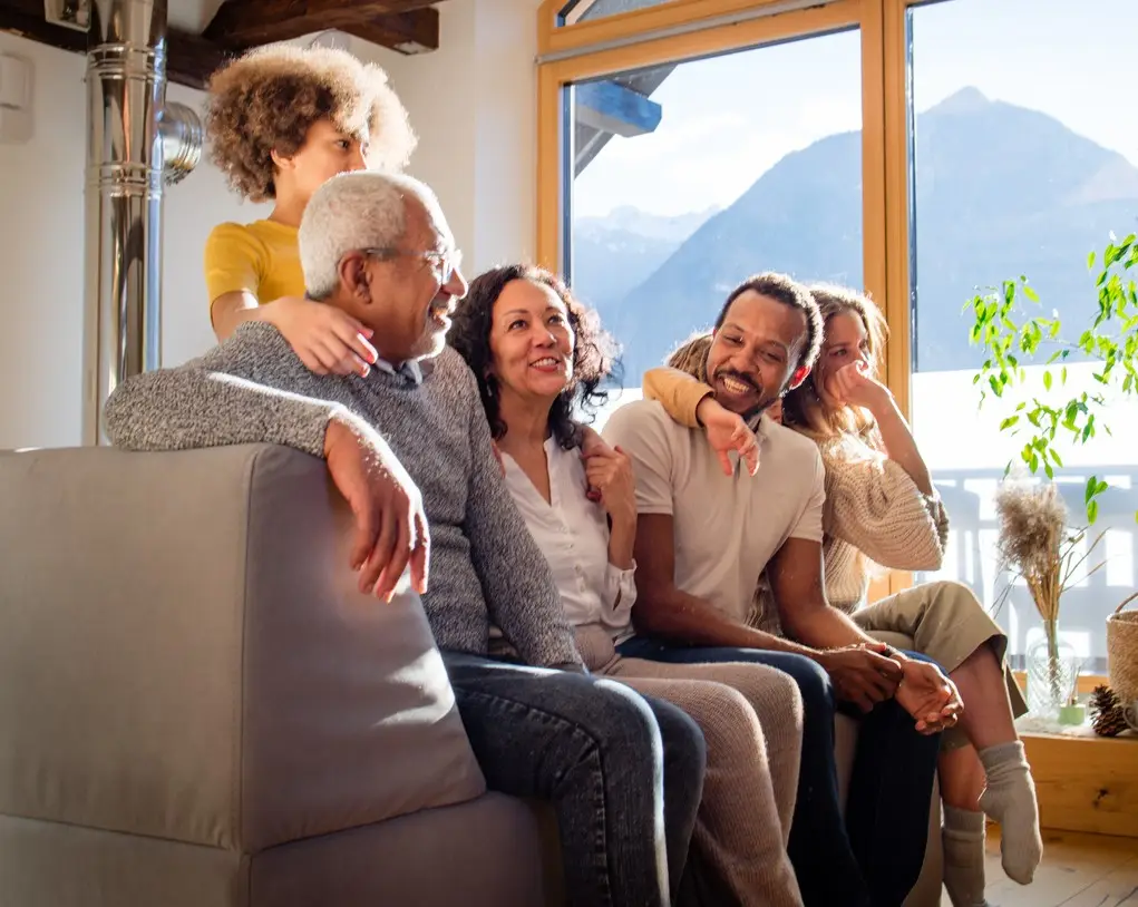 Big, happy family hanging out in a living room