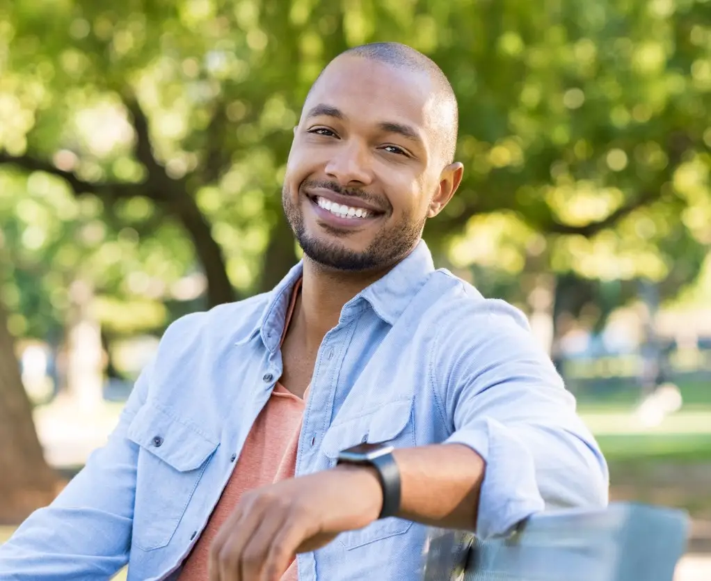 Young african man relaxing at park in a summer day.
