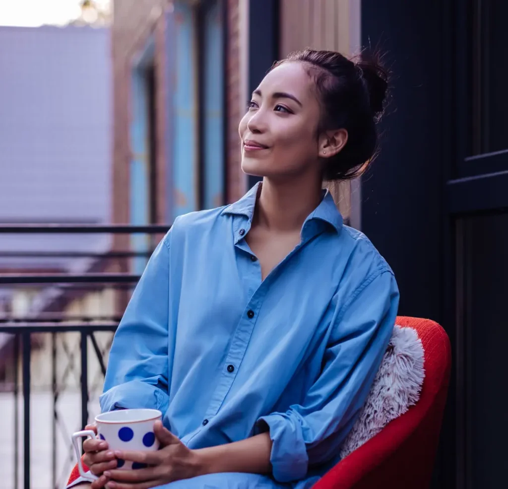 Joyful Asian woman looking at the street