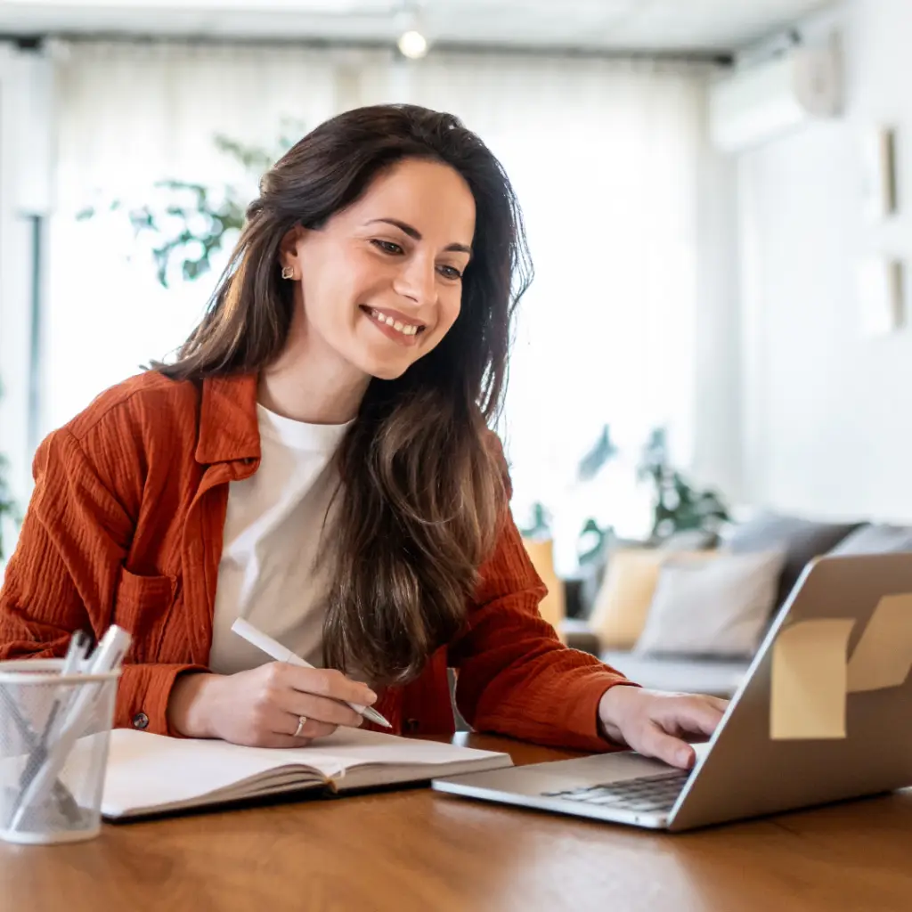 Smiling woman working on her laptop