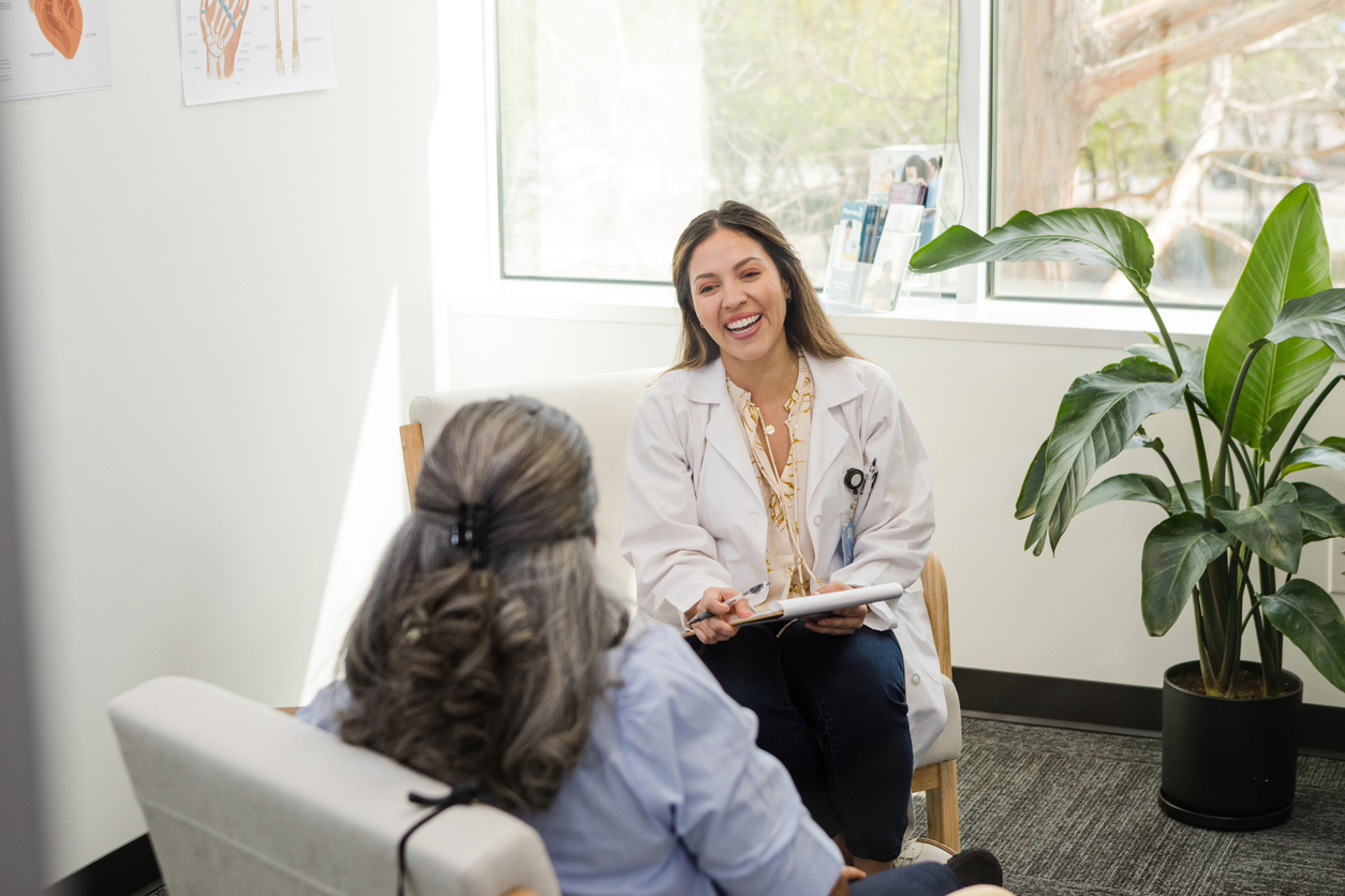 mature female doctor happy about senior woman's recovery